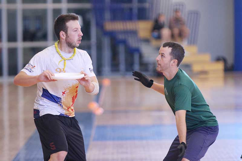 Two players square off in a game of court ultimate